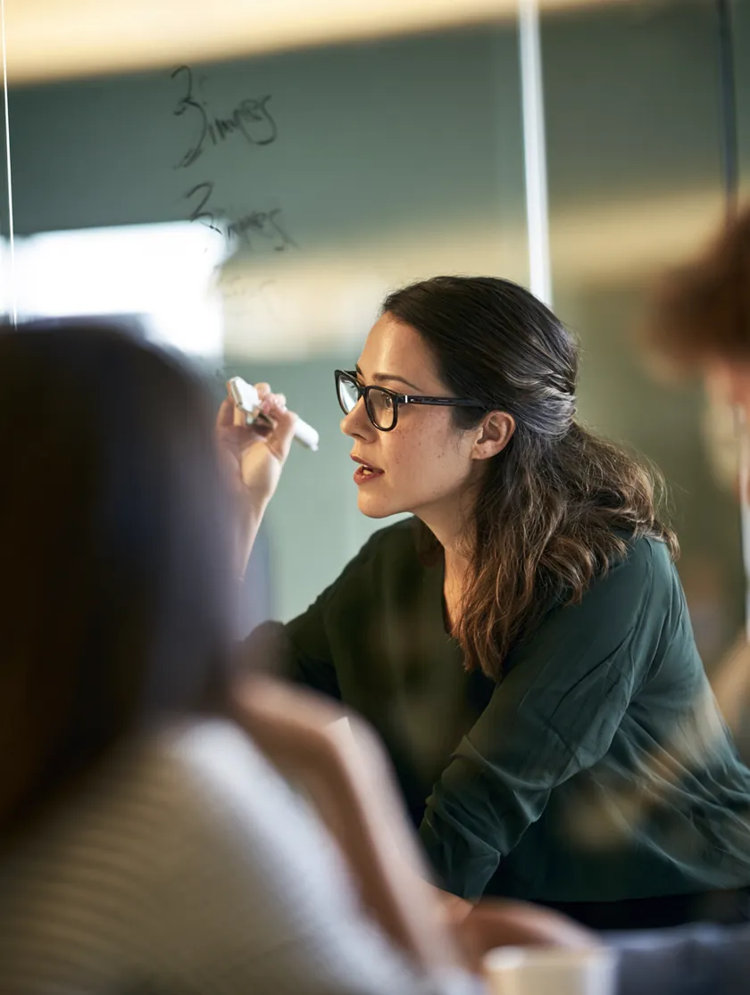 Financial planner discussing a personal loan rate chart with a client in a meeting